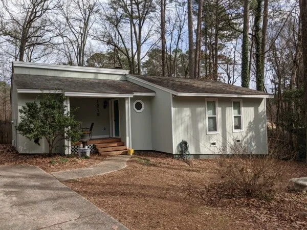 Single-story home freshly painted light gray with white trim