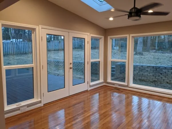 Bright addition with French doors, large windows, and hardwood floors