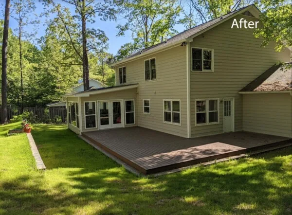 Two-story yellow home with a sunroom and deck off the back